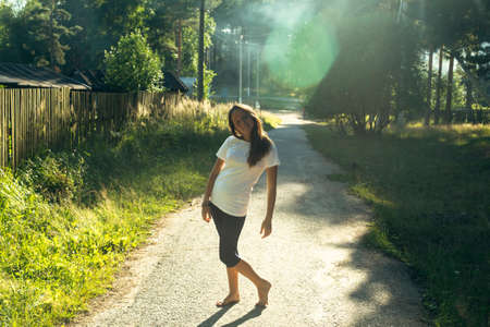 A teen girl enjoys the summer in the village.の写真素材