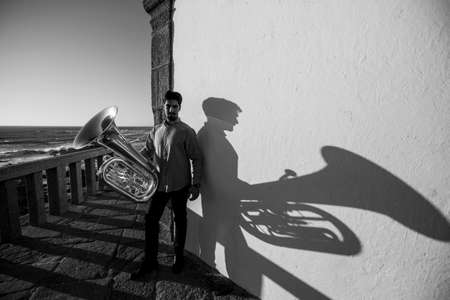 A musician man with a tuba on the Miramar beach, Porto, Portugal. Black and white photo.の写真素材
