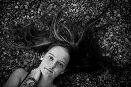 A girl is lying, a picture from above. Black and white photo.の写真素材