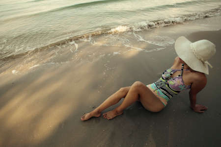 A woman is resting on the sea tropical beach.の写真素材