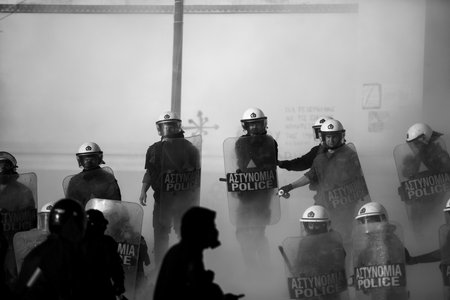 ATHENS, GREECE - APRIL 15, 2015: Riot police and protesters during a protest in front of Athens University, which is under occupation by protesters leftist and anarchist groups. Black-and-white photo.のeditorial素材