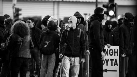 ATHENS, GREECE - APRIL 15, 2015: Riot police and protesters during a protest in front of Athens University, which is under occupation by protesters leftist and anarchist groups. Black-and-white photo.のeditorial素材