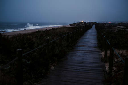 A wooden path along the Atlantic coast at dusk. The coastal Portuguese way of Santiago.の写真素材