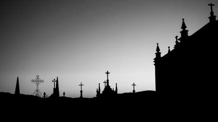Silhouettes of crosses in the cemetery during dawn. Black and white photo.の写真素材