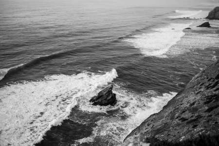 Ð¡liffs in the Atlantic Ocean, Portugal. Black and white photo.の写真素材
