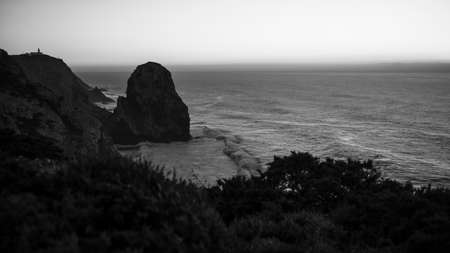 A beautiful view of the cliffs in the Atlantic Ocean at dusk, Portugal. black and white photo.の写真素材