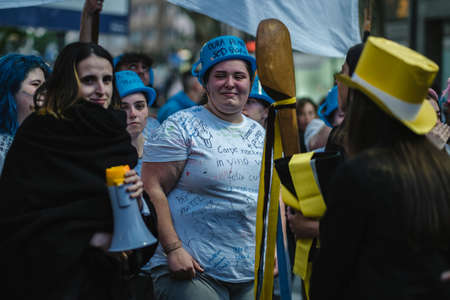 PORTO, PORTUGAL - MAY 3, 2022: During Cortejo Queima das Fitas - annual festivity of Portuguese students of universities. The graduates wear a top-hat and a walking-cane, both colors of their Faculty.のeditorial素材