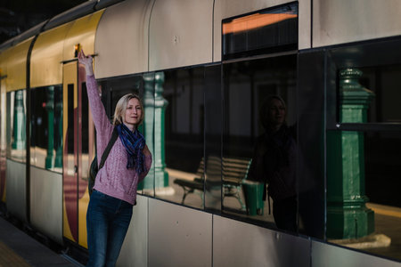 A woman meets a train on the platform.の写真素材