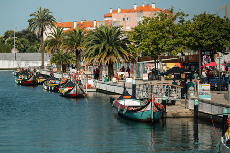 AVEIRO, PORTUGAL - JUL 7, 2022: Traditional boats "gondolas" moliceiros on the Vouga River. Through the city passes through a network of canals, so the city is sometimes called the Venice of Portugal.のeditorial素材