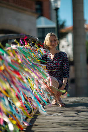 A woman on the little Bridge over a canal.の写真素材