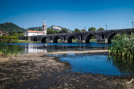 View of the long medieval bridge (ponte) that passes over the Lima river that runs next to the Ponte...