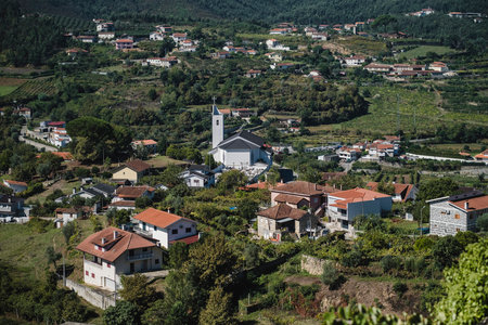 View of residential houses and a church in the hills of the Douro Valley, Porto, Portugal.の写真素材