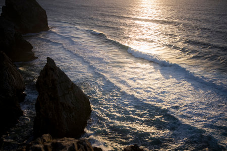 View of the cliffs and ocean surf during sunset.