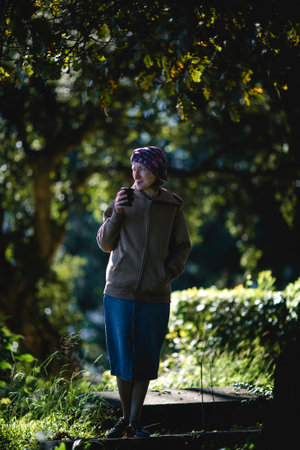 Woman in the park drinking mate from a Mate cup.