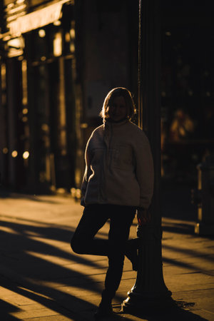 Woman on the street in the backlight during a golden sunset.