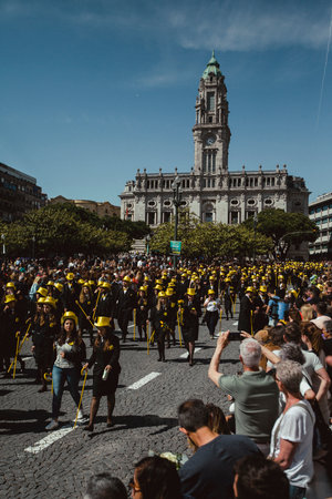 PORTO, PORTUGAL - MAY 9, 2023: Porto's Queima das Fitas Parade - annual festivity of Portuguese students of universities. The graduates wear a top-hat and a walking-cane, both colour of their Faculty.のeditorial素材