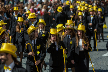 PORTO, PORTUGAL - MAY 9, 2023: Porto's Queima das Fitas Parade - annual festivity of Portuguese students of universities. The graduates wear a top-hat and a walking-cane, both colour of their Faculty.のeditorial素材