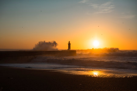 Huge wave at Lighthouse of Felgueiras in Porto during sunset, Portugal.の写真素材