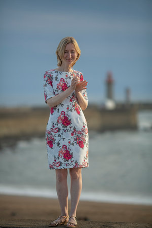 Full-length portrait of a woman posing by the sea.の写真素材