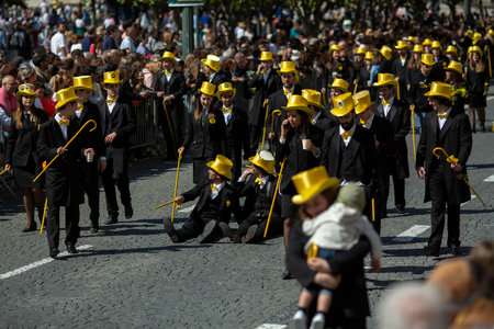 PORTO, PORTUGAL - MAY 9, 2023: Porto's Queima das Fitas Parade - annual festivity of Portuguese students of universities. The graduates wear a top-hat and a walking-cane, both colour of their Faculty.のeditorial素材