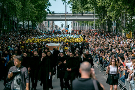 PORTO, PORTUGAL - MAY 9, 2023: Porto's Queima das Fitas Parade - annual festivity of Portuguese students of universities. The graduates wear a top-hat and a walking-cane, both colors of their Faculty.のeditorial素材