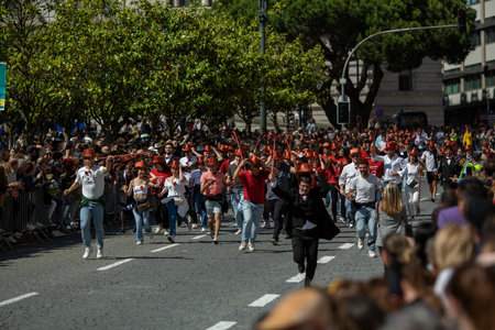 PORTO, PORTUGAL - MAY 9, 2023: Porto's Queima das Fitas Parade - annual festivity of Portuguese students of universities. The graduates wear a top-hat and a walking-cane, both colors of their Faculty.のeditorial素材