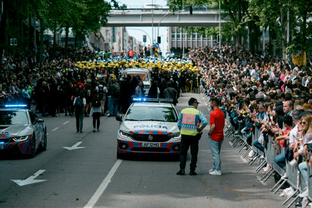 PORTO, PORTUGAL - MAY 9, 2023: Porto's Queima das Fitas Parade - annual festivity of Portuguese students of universities. The graduates wear a top-hat and a walking-cane, both colors of their Faculty.のeditorial素材