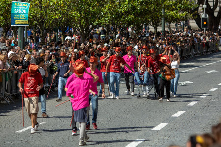 PORTO, PORTUGAL - MAY 9, 2023: Porto's Queima das Fitas Parade - annual festivity of Portuguese students of universities. The graduates wear a top-hat and a walking-cane, both colors of their Faculty.のeditorial素材