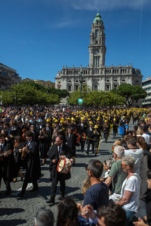 PORTO, PORTUGAL - MAY 9, 2023: Porto's Queima das Fitas Parade - annual festivity of Portuguese students of universities. The graduates wear a top-hat and a walking-cane, both colors of their Faculty.のeditorial素材
