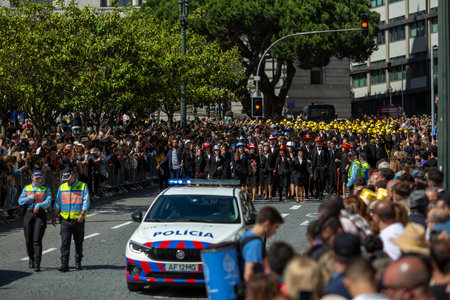 PORTO, PORTUGAL - MAY 9, 2023: Porto's Queima das Fitas Parade - annual festivity of Portuguese students of universities. The graduates wear a top-hat and a walking-cane, both colors of their Faculty.のeditorial素材