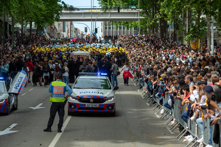 PORTO, PORTUGAL - MAY 9, 2023: Porto's Queima das Fitas Parade - annual festivity of Portuguese students of universities. The graduates wear a top-hat and a walking-cane, both colors of their Faculty.のeditorial素材