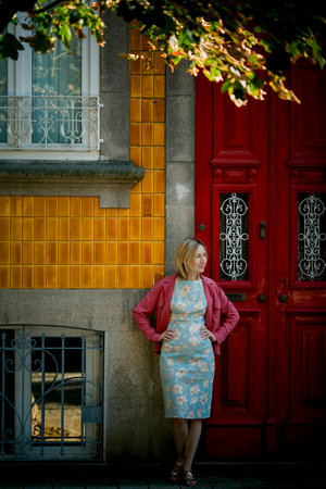 A woman stands at the door of a traditional townhouse in Porto.の写真素材