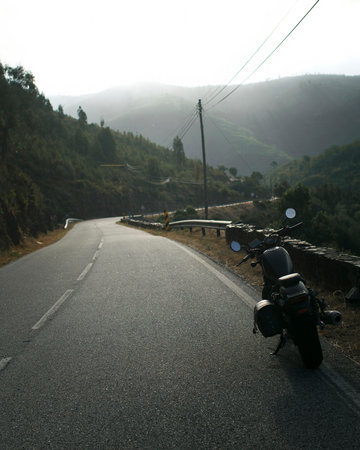 The motorcycle is parked on the side of the mountain road. Moto Travel.の写真素材