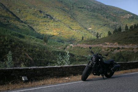The motorcycle is parked at the side of the highway.の写真素材