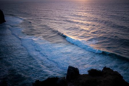 Surf on the beach at dusk on the oceanfront in Portugal.の写真素材