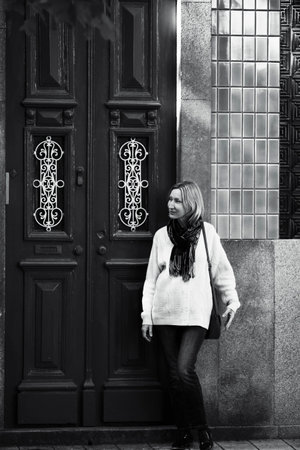 A woman at the door of a Portuguese apartment building. Black and white photo.の写真素材