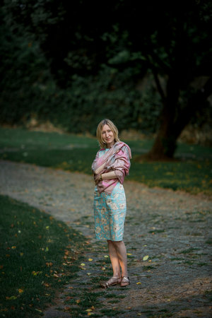 A woman is standing on a path in a park.の写真素材