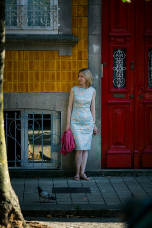A woman stands on a street in Porto, Portugal.の写真素材