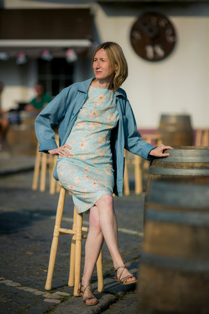 A woman sits in a beach cafe.の写真素材