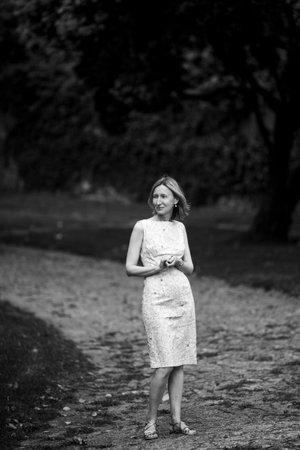 A woman stands waiting in the park. Black and white photo.の写真素材