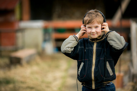 Portrait of a little happy boy wearing headphones.の写真素材