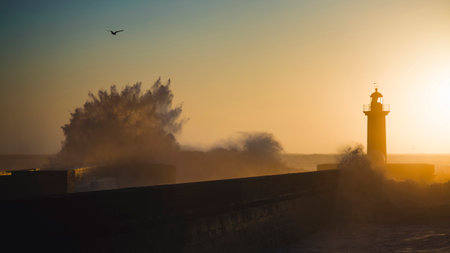 Gorgeous sunset near the Atlantic lighthouse, Porto, Portugal.の写真素材