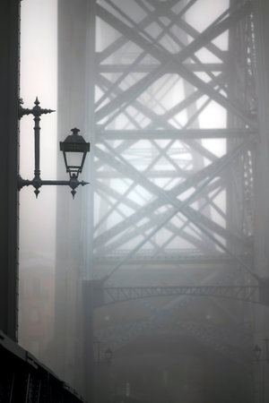 A fragment of the Dom Luis I Iron Bridge in thick fog, Porto, Portugal.