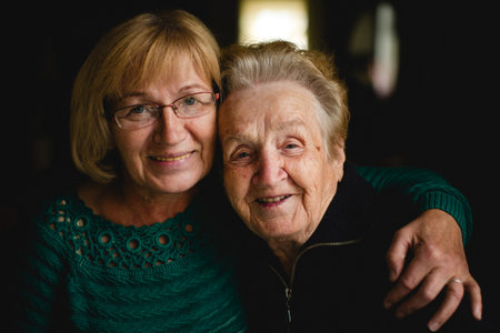 Portrait of an older woman with her adult daughter.の写真素材