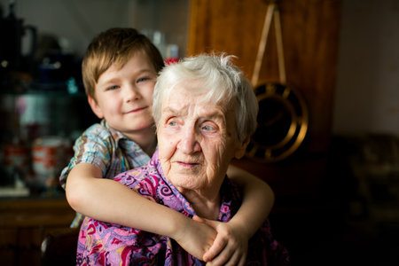 Psychological portrait of an elderly woman with her grandson.の写真素材