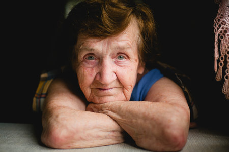 A close-up portrait of an elderly woman with a direct gaze into the camera.の写真素材