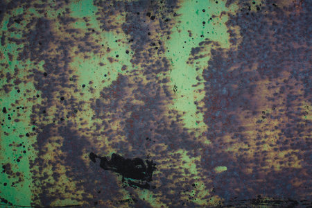 The texture of a metal surface with traces of green paint, covered in rust, revealing the passage of time.の写真素材