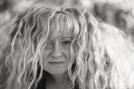 A black-and-white portrait of a woman with Slavic features and straw-colored hair, exuding timeless charm.の写真素材