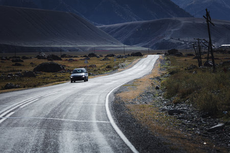 A winding road through the mountains of the Altai Republic, surrounded by stunning natural beauty.の写真素材