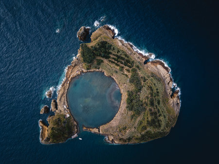 Aerial frontal view of Islet of Vila Franca do Campo in the Azores, showcasing its circular lagoon surrounded by lush greenery and the Atlantic Ocean.の写真素材